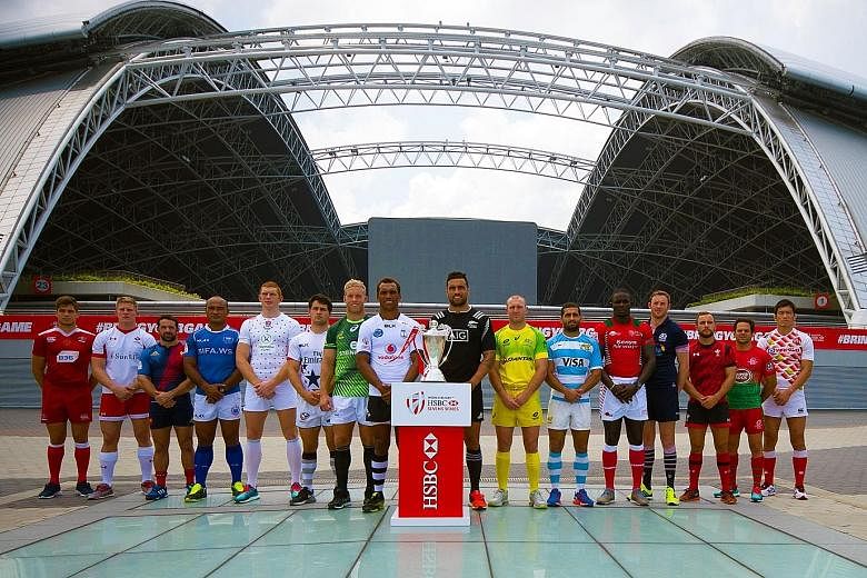 The captains of the 16 competing teams posing with the Singapore Sevens trophy. Fiji lead the standings, followed closely by New Zealand and South Africa, with Australia fourth.