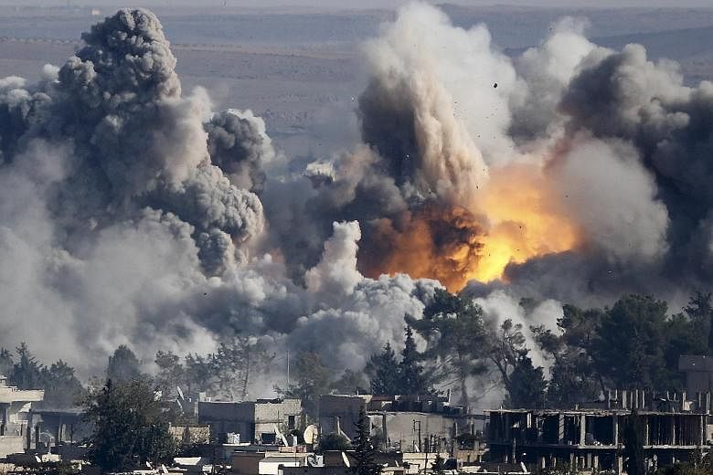 Smoke rising over the Syrian town of Kobani after an air strike in October 2014. The Islamic State in Iraq and Syria has lost cities and towns since it seized Ramadi, Iraq, almost a year ago.