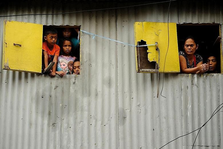 Residents of a shanty town in Manila. An ADB report says focusing on social inclusion and environmental sustainability will help Asian economies become more resilient to shocks and aid their long-term growth.