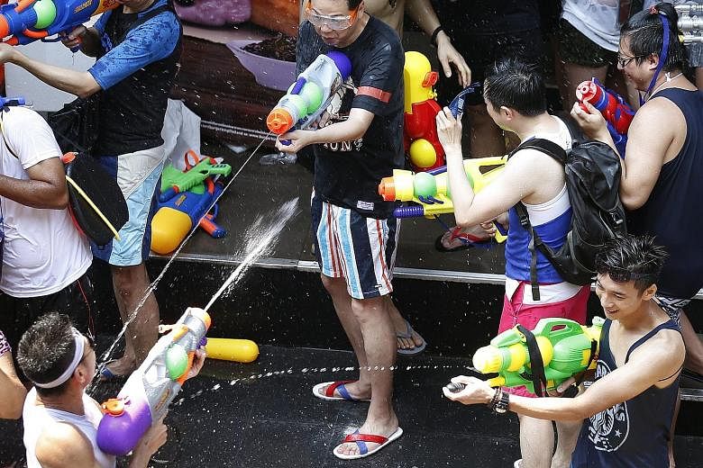 Tourists with water guns joining in the annual Songkran celebrations for the Buddhist new year in Bangkok yesterday.