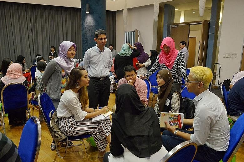 Young people from various Malay-Muslim organisations at a discussion last month about their aspirations for Singapore's future. Listening in were Associate Professor Faishal Ibrahim (standing, second from far left), Parliamentary Secretary for Minist