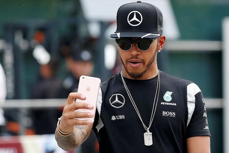 Mercedes' Lewis Hamilton taking a selfie at the Shanghai International Circuit ahead of the Chinese Grand Prix. A five-place grid penalty has been imposed on him because of a gearbox change.