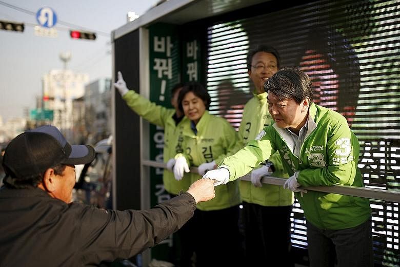 Mr Ahn greeting a supporter during hustings for Wednesday's elections, in which his People's Party won 38 seats. With the two main parties not holding a majority - Saenuri with 122 seats and Minjoo with 123 - Mr Ahn could hold the deciding vote on le