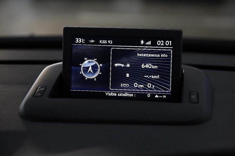 The new Peugeot 3008 (left) is decently equipped with goodies including a pop-up infotainment display (above).