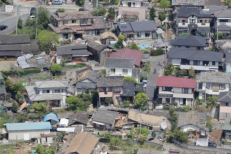An aerial view of damaged houses in the town of Mashiki in Kumamoto prefecture yesterday, after a 6.5-magnitude earthquake hit Japan's south-western island of Kyushu the night before. Mashiki, a town of around 34,000 people near the epicentre of the 