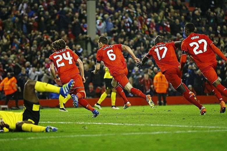 Dejan Lovren (No. 6) could be the leader of a four-man dance troupe as team-mates Joe Allen, Mamadou Sakho and Divock Origi celebrate his goal in added time to seal an amazing 4-3 Europa League victory over Borussia Dortmund on Thursday.