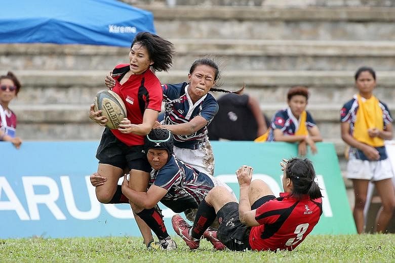Singapore's Lai Pui San in action during the 28-7 victory against Laos during the SEA 7s group matches at Yio Chu Kang Stadium yesterday. The home side will take on Thailand in today's final.