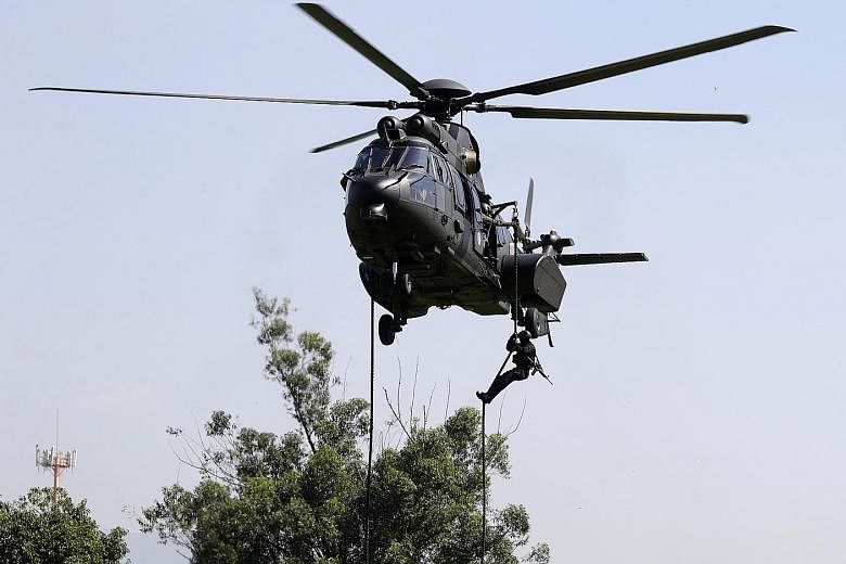 A Brazilian soldier rappelling from a helicopter as part of an exercise on April 6, in the run-up to the Olympics in August.