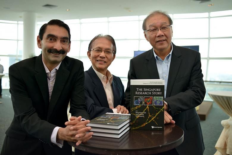 At the launch of the book are (from left) Agency for Science, Technology and Research managing director Raj Thampuran, NUS' Prof Hang and NRF's chief, Prof Low. 