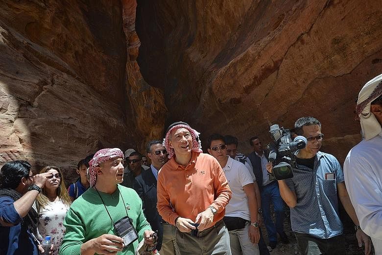 PM Lee, wearing a red-and-white keffiyeh, a symbolic headdress for Jordanians, at historic Petra, with guide Mohammad Qamhiya (in green). From left: Dr Intan, Mr Masagos and Islamic Religious Council of Singapore senior director Albakri Ahmad, speaki