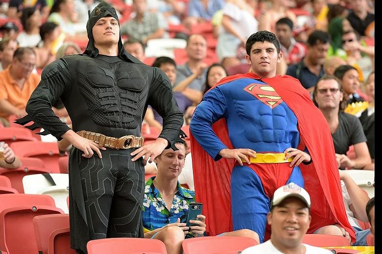 New Zealand's Sonny Bill Williams trying to break away from Canada's Pat Kay. New Zealand beat Canada 24-17 on Day 1 of the HSBC Sevens series in Singapore yesterday. This pair dressed as Batman and Superman were among the 23,000 enthusiastic rugby f