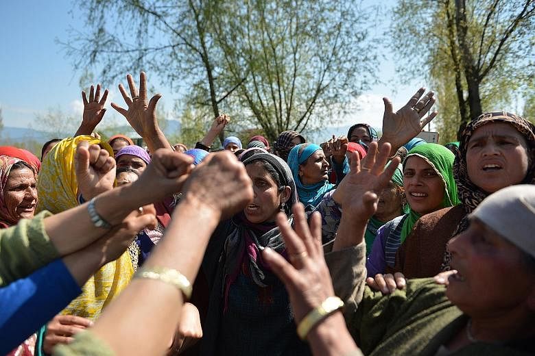 Kashmiri villagers shouting pro-freedom slogans during the funeral of a woman who was caught in crossfire during a gun battle between soldiers and militants. Locals have in recent months converged on the scene of gunfights between government forces a