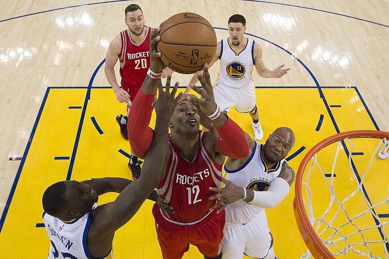Houston Rockets centre Dwight Howard shooting over Golden State Warriors forward Harrison Barnes (left) and centre Marreese Speights during Game One of the NBA Western Conference play-offs in Oakland. The Warriors' versatility was clearly evident in 