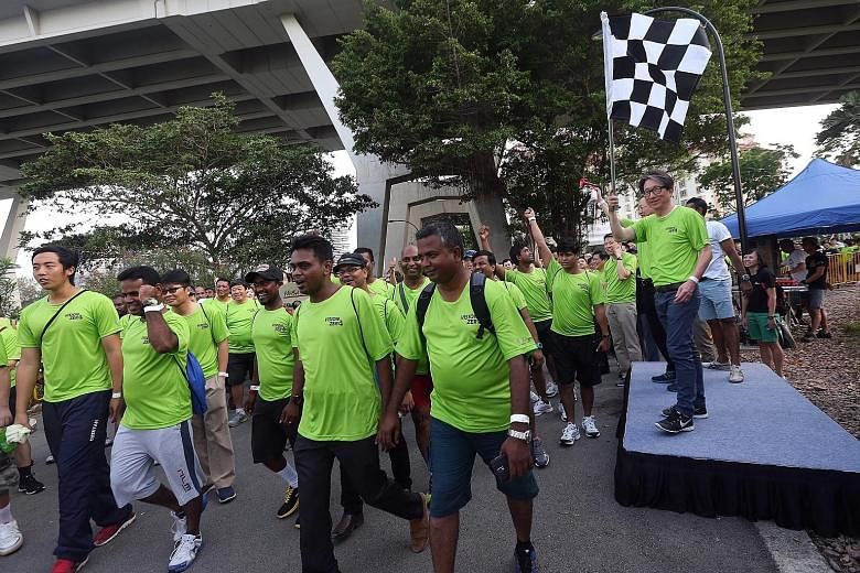 Manpower Minister Lim flagging off participants yesterday for a 3.5km walk, part of the launch of this year's National WSH Campaign. The WSH Council has a pilot programme to help over 350 SMEs in metalworking and manufacturing to improve workplace sa