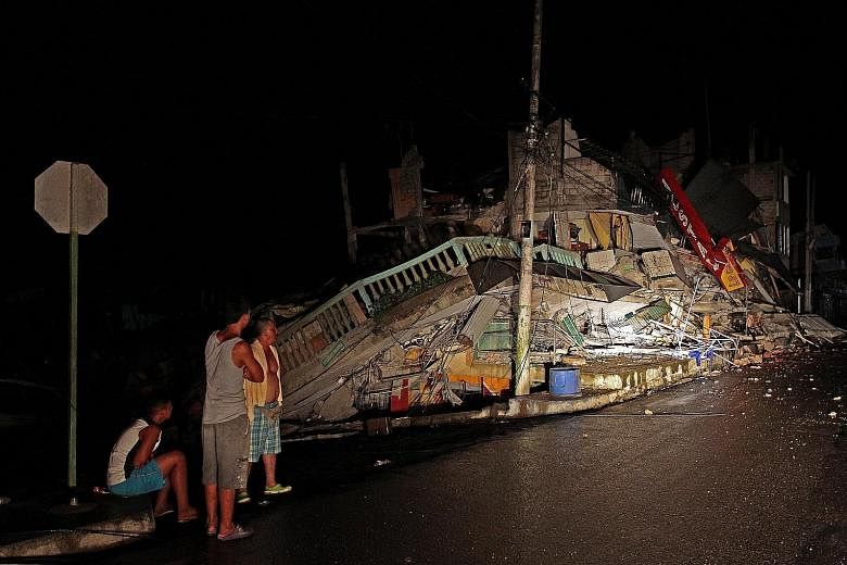 A collapsed building in Pedernales town, Ecuador, yesterday. The town's mayor described the 7.8-magnitude earthquake that struck the country as catastrophic, with some villages "totally devastated".