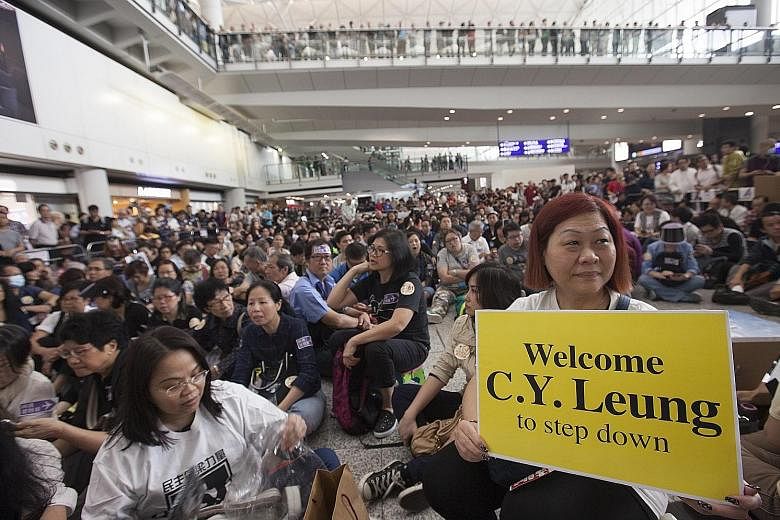 A large crowd staging a sit-in at Hong Kong's International Airport yesterday to protest against preferential treatment that was allegedly extended by airline staff to Hong Kong Chief Executive Leung Chun Ying's daughter. About a week ago, she allege