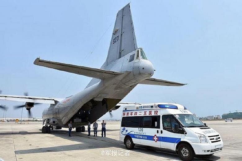 The Chinese military aircraft at the airport in Sanya, Hainan island, after evacuating three seriously ill workers from Fiery Cross Reef in the South China Sea on Sunday.