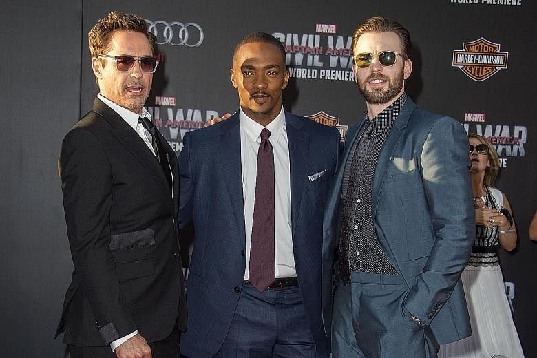 Captain America stars Anthony Mackie (above left) and Chris Evans are scheduled to walk the blue carpet for the movie in Singapore tomorrow.