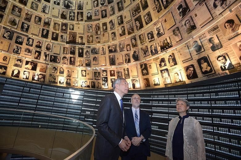 PM Lee and Mrs Lee with Dr Robert Rozett, Yad Vashem Libraries director, inside the Hall of Names at the memorial for victims of the Holocaust, in Jerusalem yesterday.