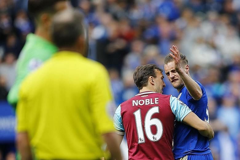 A frustrated Jamie Vardy had to be restrained by West Ham's Mark Noble while leaving the field after being sent off. Referee Jon Moss showed Leicester's top scorer a second yellow card for simulation.