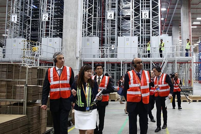 Accompanying Mr Tharman on his tour of the new facility are Dr Appel (left), DHL chief, and Ms Felicia Tan, DHL's IT vice-president for Indonesia, Malaysia and Singapore.