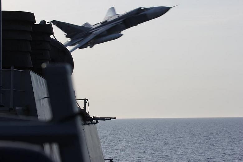 A US Navy picture shows a Russian Sukhoi SU-24 aircraft flying past the USS Donald Cook in the Baltic Sea on April 12.