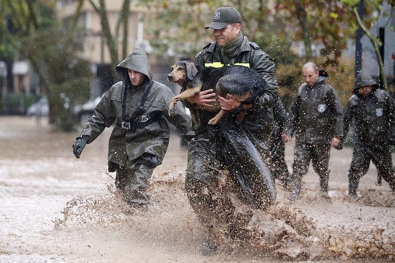 Heavy flooding has also affected parts of South America. In Chile, a policeman rescues a dog during a downpour in the capital Santiago. Four days of rain, which intensified over the weekend, sent water tumbling off the Andes mountains and into Santiago, c