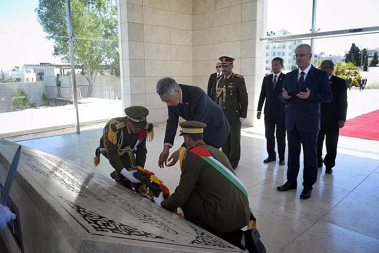 Prime Minister Lee Hsien Loong placing a wreath at the mausoleum of the first Palestinian Authority president, Mr Yasser Arafat, in Ramallah yesterday. He was accompanied by Palestinian Prime Minister Rami Hamdallah, Foreign Minister Vivian Balakrish