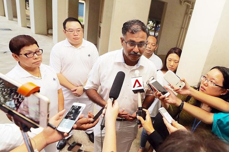 Lawyer Murali Pillai, the PAP's candidate for the by-election, speaking to reporters yesterday after house visits in Bukit Batok SMC. Among residents' top concerns is adequate help in the economic slowdown, he said.
