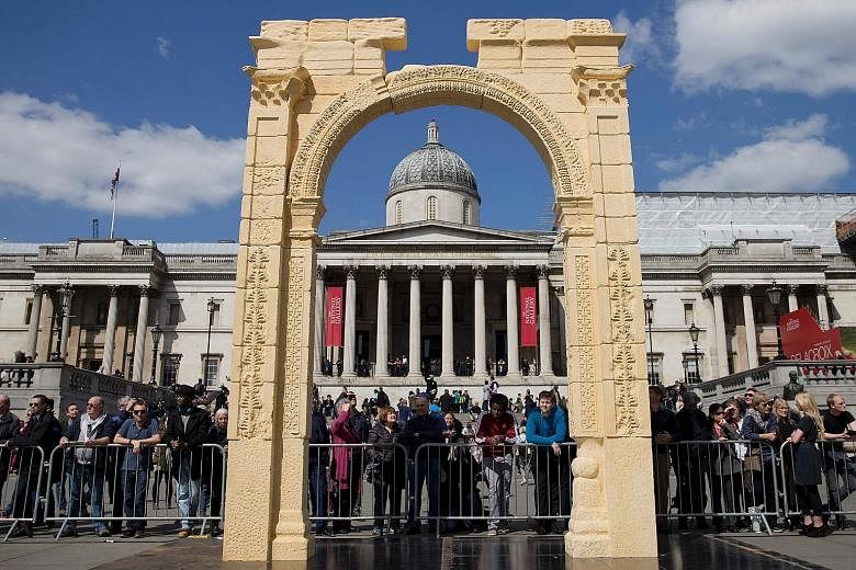 A replica of the destroyed Arch of Triumph in Syria's city of Palmyra, set in front of the National Portrait Gallery, after being unveiled on Tuesday to a crowd of hundreds in Trafalgar Square in central London. The original arch was blown up by the 