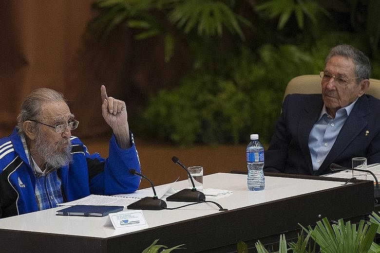 Former Cuban leader Fidel Castro, clad in a blue track jacket, with his brother, Cuban President Raul Castro, at the close of the VII Cuban Communist Party Congress in Havana on Tuesday. Dr Castro, 89, bade farewell to the Communist Party, telling pa