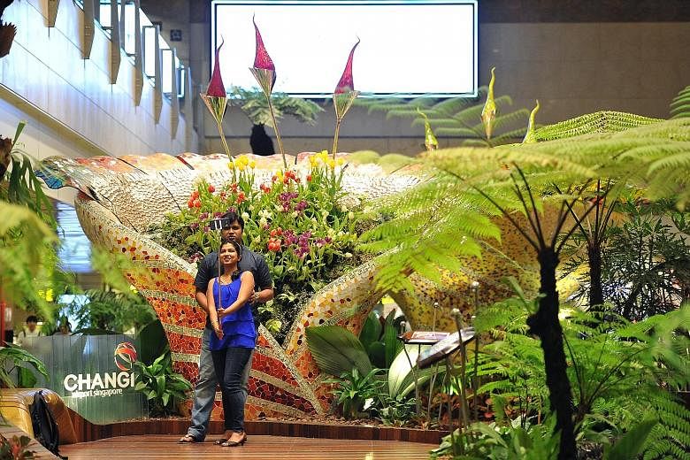 IT trainer Trivikram Baindur, 32, and IT developer Sonal Kini, 29, both tourists from India on transit at Changi Airport, taking a selfie at the tulip display at the airport's Enchanted Garden last week.