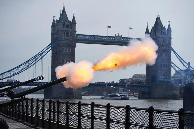 London's Tower Bridge was the backdrop for one of the two military gun salutes in the British capital to mark the Queen's birthday. The other was at Hyde Park. The Queen greeting well-wishers outside Windsor Castle yesterday. She has been on the thro