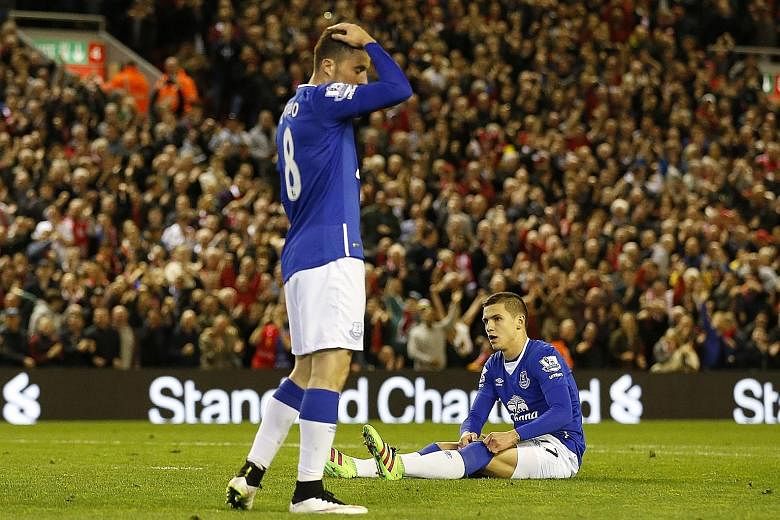 The pain is evident in the body language of Everton duo Muhamed Besic (sitting) and Bryan Oviedo after the 4-0 defeat at the hands of Liverpool on Wednesday. Roberto Martinez has challenged his side, suffering their worst season at home in the 138-ye