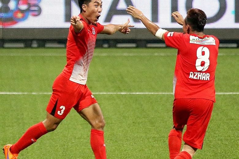 Song Ui Young being greeted by team-mate Azhar Sairudin after the South Korean midfielder scored Home United's first goal in the 20th minute.