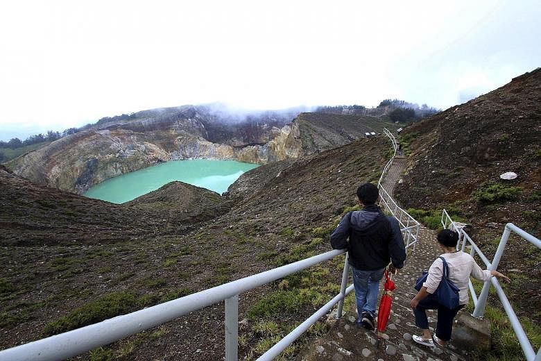 Visitors make their way towards a lake on Kelimutu volcano, a popular tourist site, near Ende on the Flores archipelago.