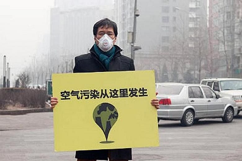 Mr Quek holding up a sign which says "Air Pollution Comes From Here" in Beijing in 2014. Debunking the stereotype of a strident agitator, Mr Quek speaks in the measured tones of a thinker. He is the go-to person for researchers, investors and policym