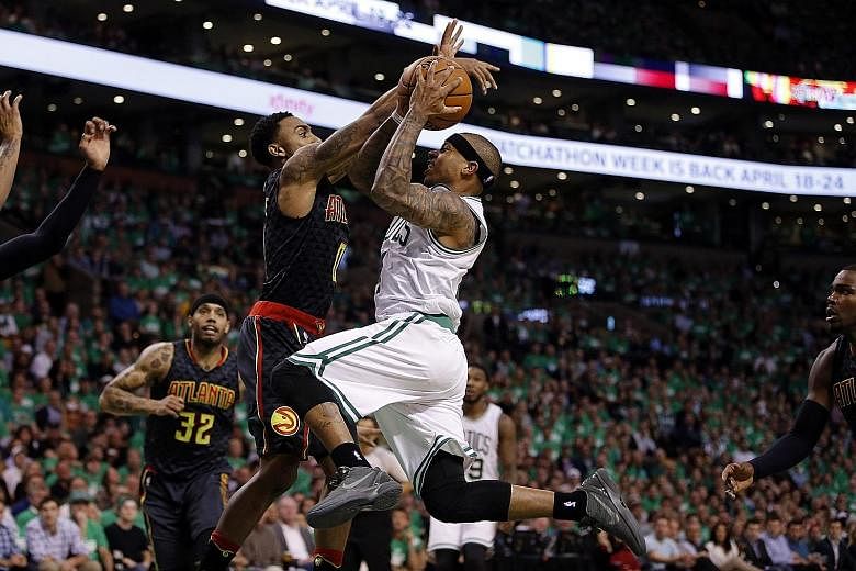 Boston guard Isaiah Thomas going up for a shot, as Atlanta guard Jeff Teague blocks him in Game 3 of their NBA Eastern Conference first-round play-offs at TD Garden. Thomas enjoyed a career-high 42 points in the 111-103 victory.