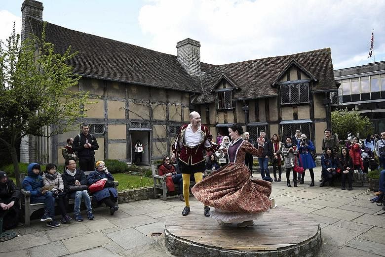 Tourists watch performers at the house where William Shakespeare was born during celebrations to mark the 400th anniversary of his death in Stratford- Upon-Avon last Saturday.