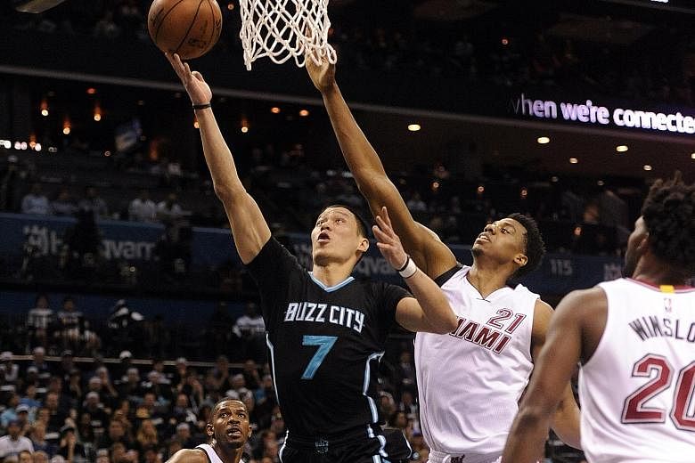 Charlotte Hornets guard Jeremy Lin drives past Miami Heat's Hassan Whiteside (21) for a lay-up during Game Three of their first round play-off series at the Time Warner Cable Arena. The Hornets' 96-80 win over the Heat was their first post-season win
