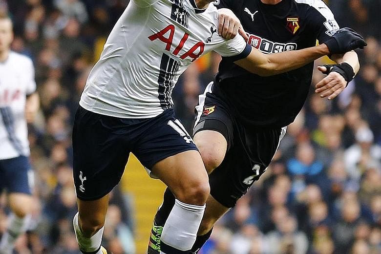 Tottenham's Erik Lamela holding off the challenge of Watford's Ben Watson during a Premier League meeting between their two sides in February. The Argentinian has come a long way, from failing to impress in his debut season, to being part of an attac