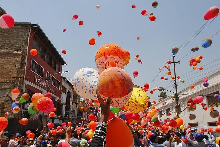 People in Nepal releasing balloons at Kathmandu Durbar Square last Saturday in memory of the 9,000 people killed in an earthquake that hit the country a year ago. 	Thousands of people gathered at the tourist landmark, which was damaged during the 7.8