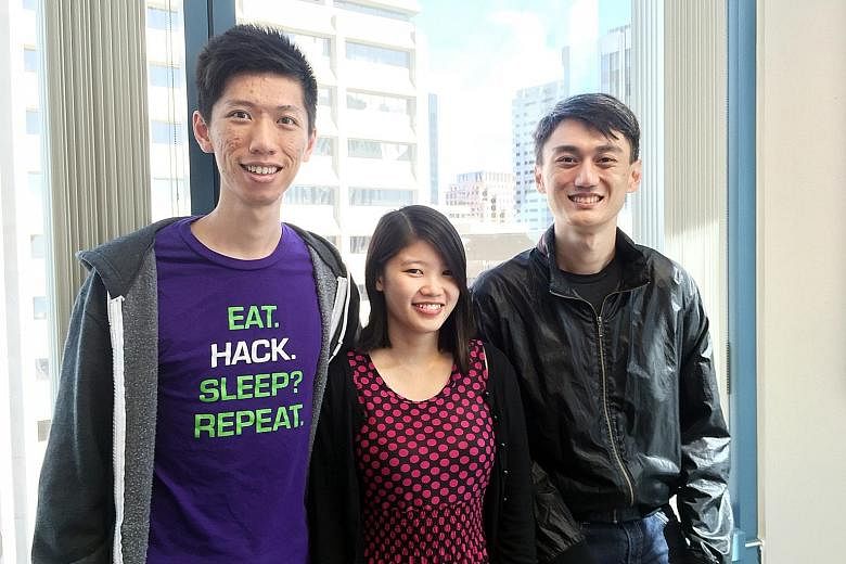 Co-founders of KeyReply (from left) Max Xu, Carylyne Chan and Spencer Yang. The firm designs AI chatbots for online service providers. The bots respond to customer chat enquiries and requests. Banners with distinctly Singaporean messages decorate the