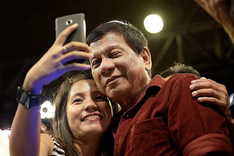 A supporter taking a selfie with Davao mayor and presidential candidate Rodrigo Duterte, 71. Mr Duterte has promised to wipe out drugs, crime and graft within six months, if elected president in the May 9 polls.