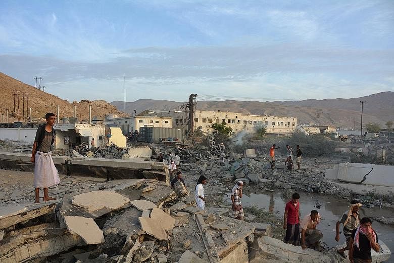 The site of one of Sunday's air strikes in the port city of Al Mukalla, Yemen. The Saudi-led coalition said many militants fled the provincial capital that they had held for a year after the offensive.