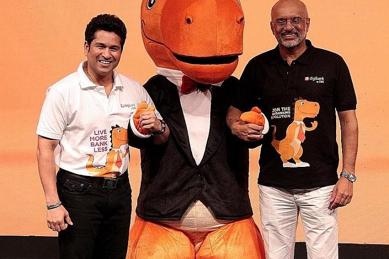 Cricket legend Sachin Tendulkar (left) and DBS Bank CEO Piyush Gupta at the launch of digibank. With them is dinosaur mascot Digor, who symbolises change and thriving in a digital age.