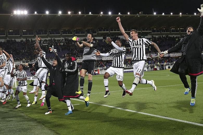 Jubilant Juventus players celebrate their 2-1 win over Fiorentina on Sunday. Napoli's loss to Roma on Monday meant that Juve are confirmed Serie A champions for a fifth straight season.