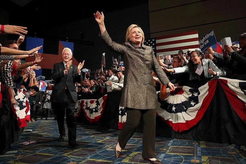 Mrs Clinton waving to the audience as she arrived with her husband, former United States president Bill Clinton, to speak to supporters during her five-state primary night rally in Pennsylvania on Tuesday. Mr Trump claims the "only card she has is th