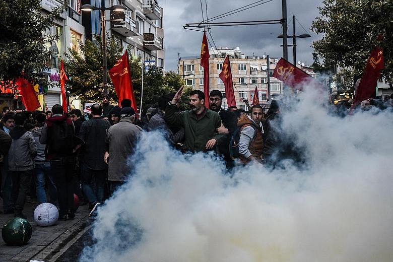Anti-riot police using tear gas on Tuesday to disperse demonstrators during a protest at Kadikoy district in Istanbul against a call for the country to adopt a religious Constitution.