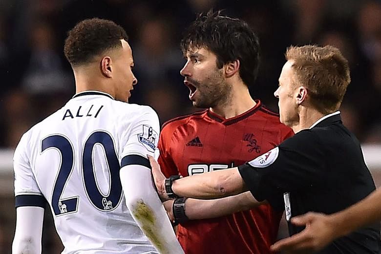 Tottenham midfielder Dele Alli exchanges angry words with West Brom's Claudio Yacob. The Spurs player was caught punching Yakob in an off-the-ball incident and may miss the rest of the season. 